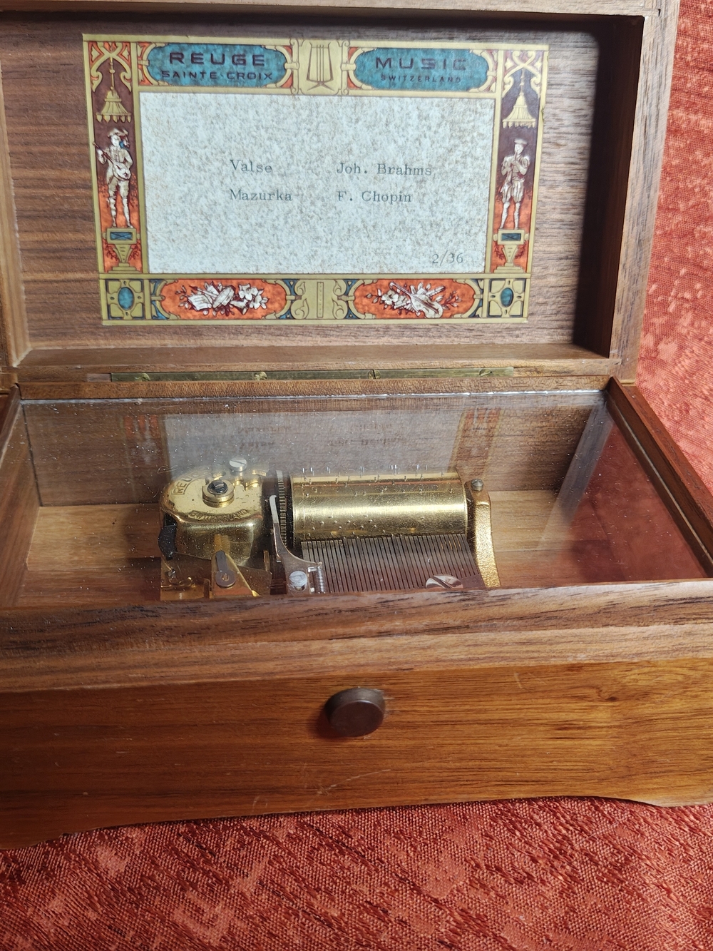 Vintage Reuge Sainte-Croix Swiss cylinder music box in wooden case with a glass